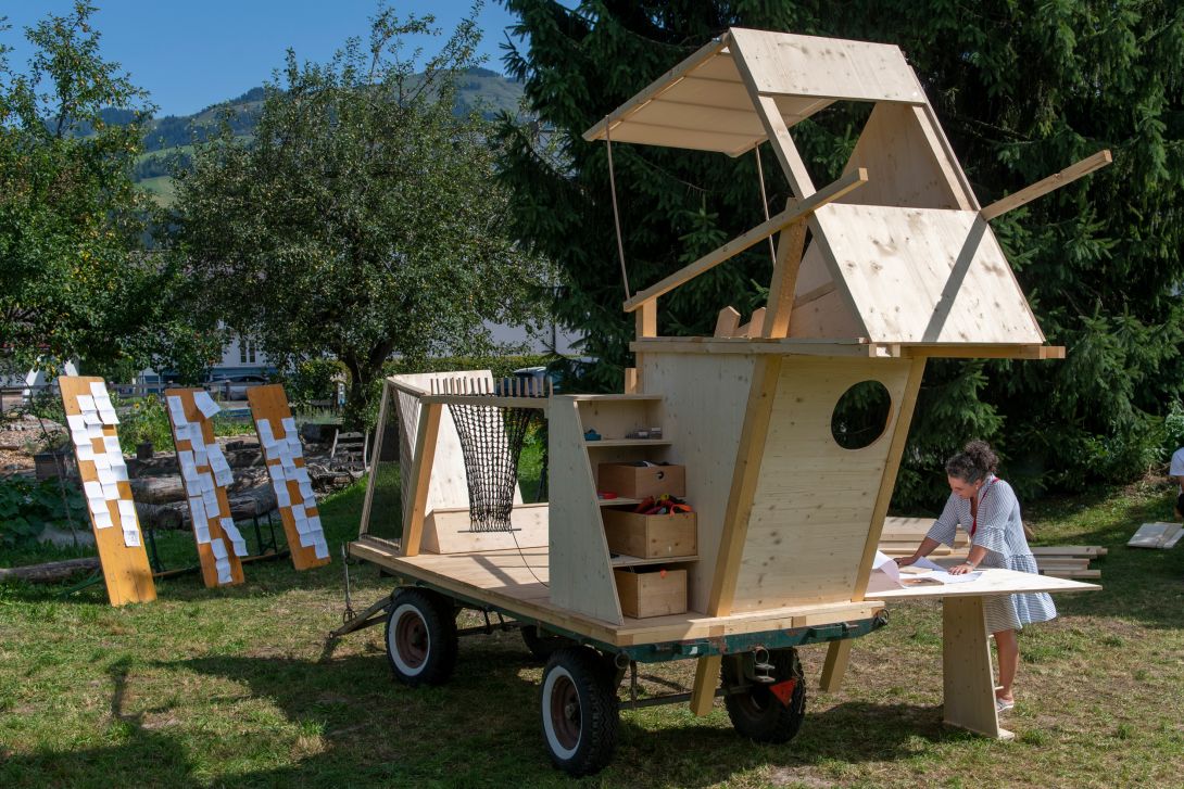 Ein Wagen aus Holz. Im Hintergrund Berge.